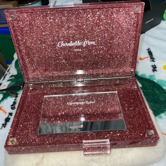 Learn More
Gorgeous Charlotte Max Lucite clutch
Purole pink w glitter detail - Picture 4 of 5